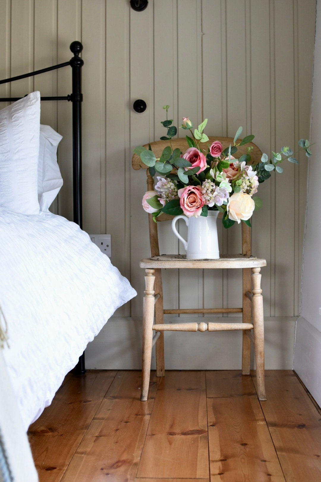 Pink, peach and ivory roses set amongst green eucalyptus foliage.